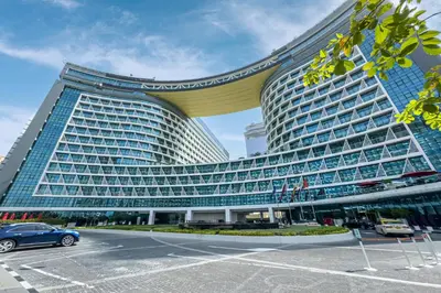 a large building with a car parked in a parking lot at Beach access I Sea View I Infinity pool in Dubai