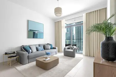a living room with a couch and a table at Stunning 3 Bedroom Apartment with Fountain Views by ZEN STAYS - Sleeps 9 - 2 Balconies in Dubai