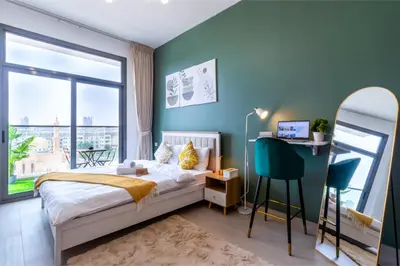 a bedroom with a bed and a large window at Sky View, Furnished, FreeParking in Dubai