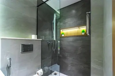 a shower with a glass door in a bathroom at Sky View, Furnished, FreeParking in Dubai