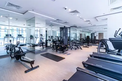 a gym with treadmills and elliptical machines at Sky View, Furnished, FreeParking in Dubai