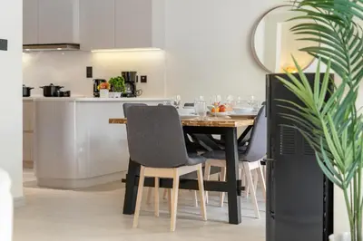 a dining room table and chairs in a kitchen at Backyard Bliss Villa in The Lakes 3BR plus maid's room in Dubai