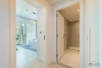 a hallway with a door leading to a bathroom at Sophisticated 1BR Apartment in La Vie, Jumeirah Beach Residences by Deluxe Holiday Homes in Dubai