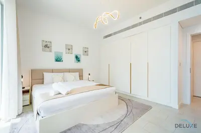 a white bedroom with a large white bed in it at Sophisticated 1BR Apartment in La Vie, Jumeirah Beach Residences by Deluxe Holiday Homes in Dubai