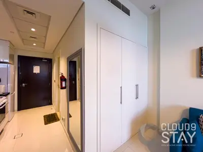 a room with a white closet and a door at Cloud 9 - DAMAC Ghalia Tower in Dubai