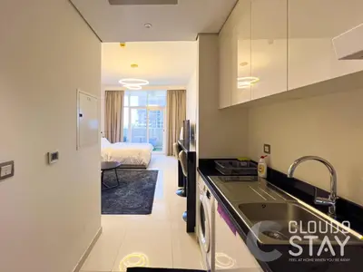 a kitchen with a sink and a bed in a room at Cloud 9 - DAMAC Ghalia Tower in Dubai