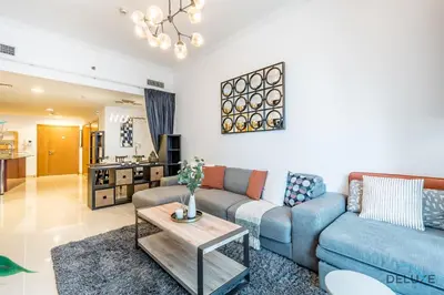 a living room with a couch and a table at Charming 1BR Apartment at Ocean Heights Dubai Marina by Deluxe Holiday Homes in Dubai