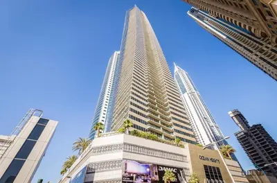 a tall building with palm trees in front of it at Charming 1BR Apartment at Ocean Heights Dubai Marina by Deluxe Holiday Homes in Dubai