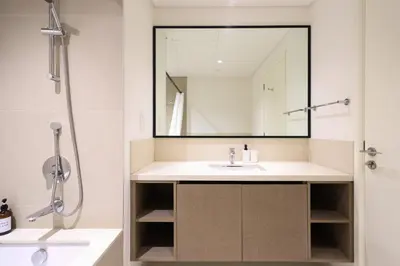 a bathroom with a sink and a mirror at Downtown Apartments - Burj Crown - 5 Min Walk to Mall in Dubai