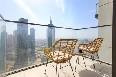 two chairs and a table on a balcony with a view at Sea & City Views - Burj Crown - 5 Min Walk to Mall in Dubai