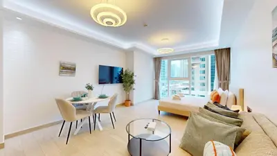 a living room with a couch and a table at Primestay - Elevated Studio in JLT - Dubai in Dubai