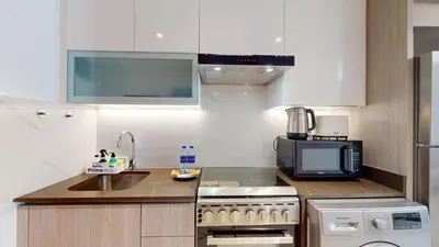 a kitchen with a sink and a stove and a microwave at Primestay - Elevated Studio in JLT - Dubai in Dubai