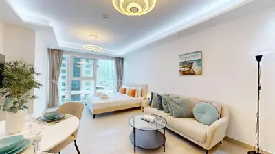 a living room with a couch and a table at Primestay - Elevated Studio in JLT - Dubai in Dubai