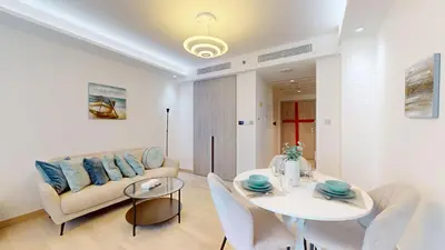 a living room with a couch and a table at Primestay - Elevated Studio in JLT - Dubai in Dubai