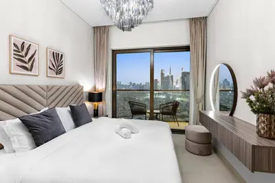 a bedroom with a white bed and a large window at FIRST CLASS Luxury 1BR plus Bunk Room in Sobha Waves, Close to Downtown Dubai in Dubai