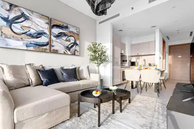 a living room with a couch and a table at FIRST CLASS Luxury 1BR plus Bunk Room in Sobha Waves, Close to Downtown Dubai in Dubai