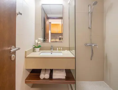 a bathroom with a sink and a shower at Silkhaus Burj Khalifa View Studio in Iconic Tower in Dubai
