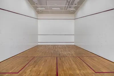 an empty room with white walls and a wooden floor at Silkhaus Modern Studio with Balcony in Burj Daman in Dubai