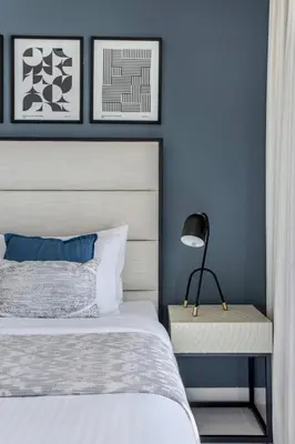 a bedroom with a bed and a table with a lamp at Frank Porter - Marina Vista Podium 3 in Dubai