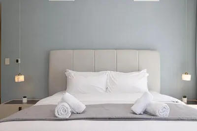 a white bed with two pillows on top of it at JuliusHomes - 5BR Villa with Pool in Palm Jumeirah in Dubai