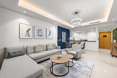a living room with a couch and a table at FIRST CLASS 2BR Luxurious High-Floor Suite in Dubai
