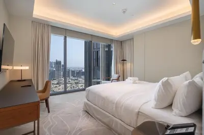 a hotel room with a bed and a desk and a window at Address Residences Dubai Opera - Burj Khalifa City Views 1, 2, & 3-Bedroom Apartment 1 minute walk to Burj Khalifa, Dubai Mall, Dubai Fountain by Heaven Crest in Dubai