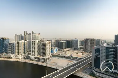 an aerial view of a city with a bridge and buildings at Oraya - Upgraded 2BR In Prive Maison, Central Canal View in Dubai