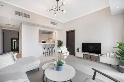 a living room with a couch and a table at Daniels 1BR at Silverene Tower Dubai Marina in Dubai