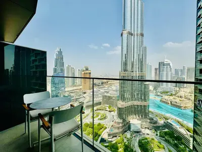 a balcony with a view of a city at Vista Luxe 3 Bedroom at Address Opera I Burj Khalifa & Fountain Views in Dubai