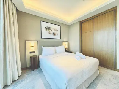 a hotel room with a large white bed and curtains at Vista Luxe 3 Bedroom at Address Opera I Burj Khalifa & Fountain Views in Dubai