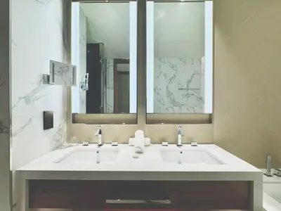 a bathroom with a white sink and a mirror at Vista Luxe 3 Bedroom at Address Opera I Burj Khalifa & Fountain Views in Dubai