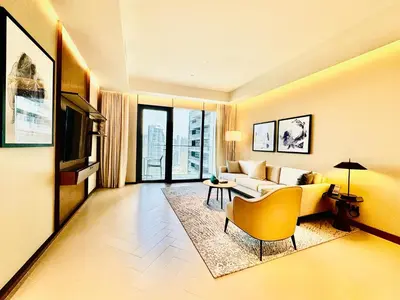 a living room with a couch and a table at Vista Luxe 3 Bedroom at Address Opera I Burj Khalifa & Fountain Views in Dubai