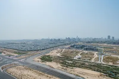 an aerial view of a highway with a city in the background at Inviting Studio in Damac Hills Carson B, Dubailand by Deluxe Holiday Homes in Dubai