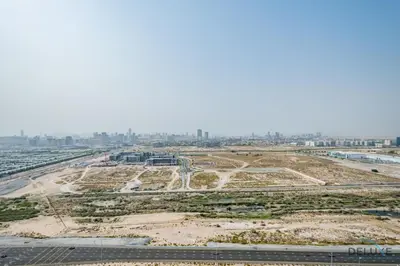 an aerial view of a construction site with a city in the background at Inviting Studio in Damac Hills Carson B, Dubailand by Deluxe Holiday Homes in Dubai