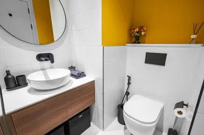 a bathroom with a sink and a toilet and a mirror at Premium Studio Apartment at Loci Residences JVC in Dubai