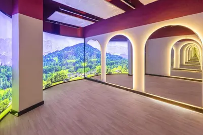 a room with a balcony with a view of mountains at Premium Studio Apartment at Loci Residences JVC in Dubai