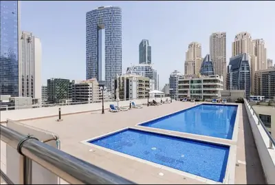 a swimming pool on the roof of a building at First Line Canal View Studio with Balcony MAX 4 Pax in Dubai