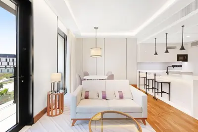 a living room with a white couch and a table at Vonder Bluewaters Residences SA2 in Dubai