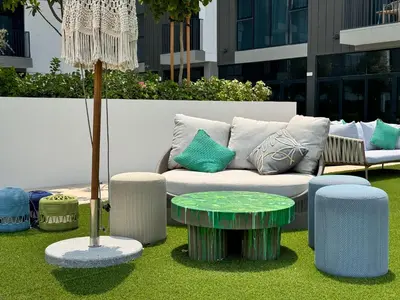 a couch and a coffee table in a yard at Chic 1 BR apartment at Golfville in Dubai
