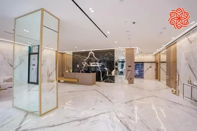 a lobby with a large glass door in a building at Alashrafia Saray - Bright 1bdr apartment in JVC in Dubai