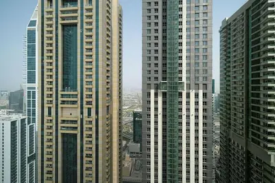 a group of tall buildings in a city at Lux 2BR with Sea Views in Marina in Dubai