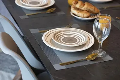 a table with plates and spoons and bread on it at Lux 2BR with Sea Views in Marina in Dubai