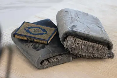 a book and a broom on a table at Brand New 1BR with Pool, Sauna & Gym in Dubai