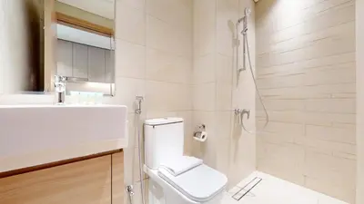 a bathroom with a toilet and a sink and a shower at Azizi Riviera 47 - Comfortable Studio in Meydan in Dubai