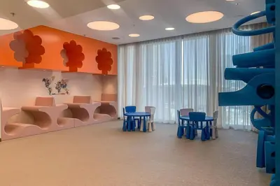a waiting room with blue chairs and orange walls at Locations I Spacious Modern 3 Bedroom I Luxury Stay Near Dubai Mall & Burj Khalifa I Pool, Gym, Parking & Wi-Fi in Dubai