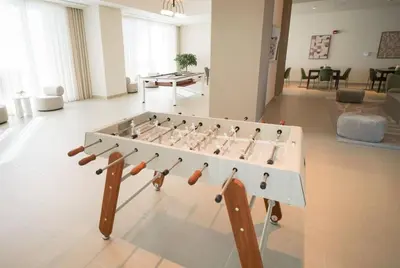 a foosball table in the middle of a living room at Locations I Spacious Modern 3 Bedroom I Luxury Stay Near Dubai Mall & Burj Khalifa I Pool, Gym, Parking & Wi-Fi in Dubai