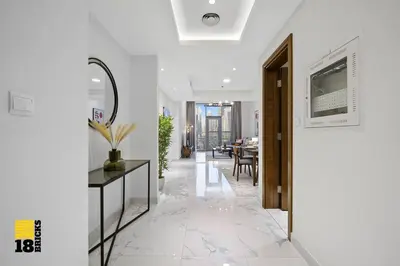 a hallway with a table and a dining room at Spacious and Peaceful 1BR with Canal views in Dubai