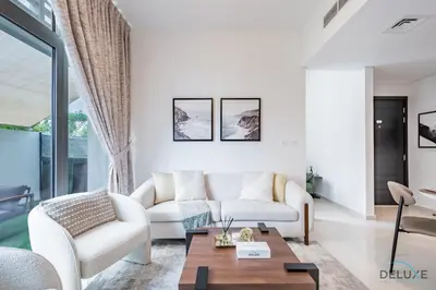a living room with white furniture and a table at Stylish 1BR Apartment in Damac Hills 2 Avencia 45, Dubailand by Deluxe Holiday Homes in Dubai
