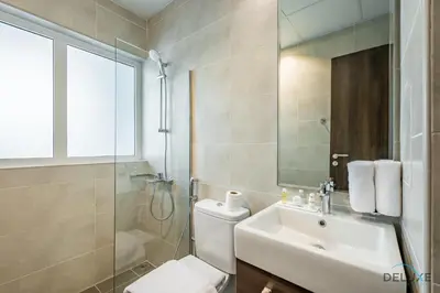 a bathroom with a toilet and a sink and a shower at Stylish 1BR Apartment in Damac Hills 2 Avencia 45, Dubailand by Deluxe Holiday Homes in Dubai