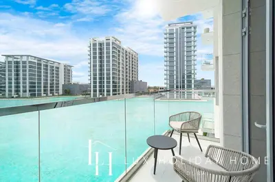a balcony with two chairs and a table on a building at LUX The Burj Khalifa Lagoon View Suite 2 in Dubai